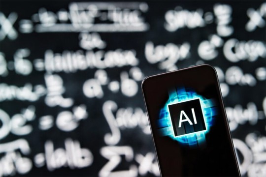 Smartphone displaying an AI logo in front of a blurred blackboard filled with mathematical equations.