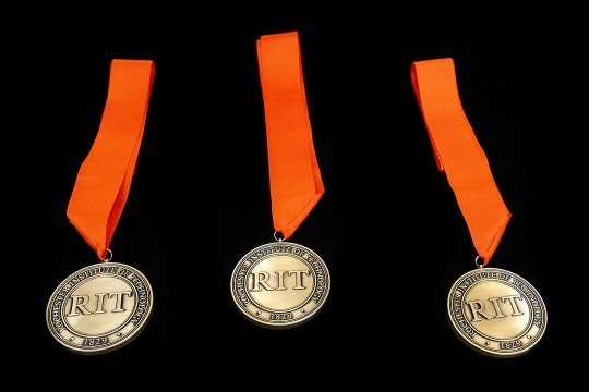 a series of 3 medals with orange ribbons are shown on a black background