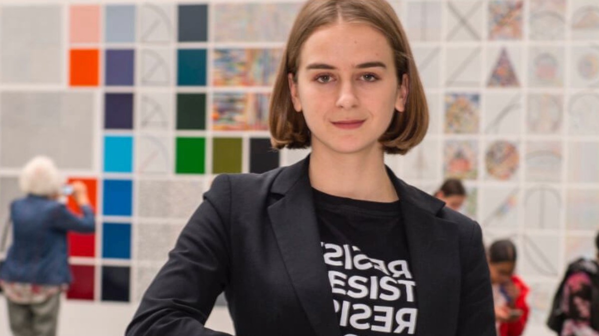 An R I T student posing for a photo in their workplace.