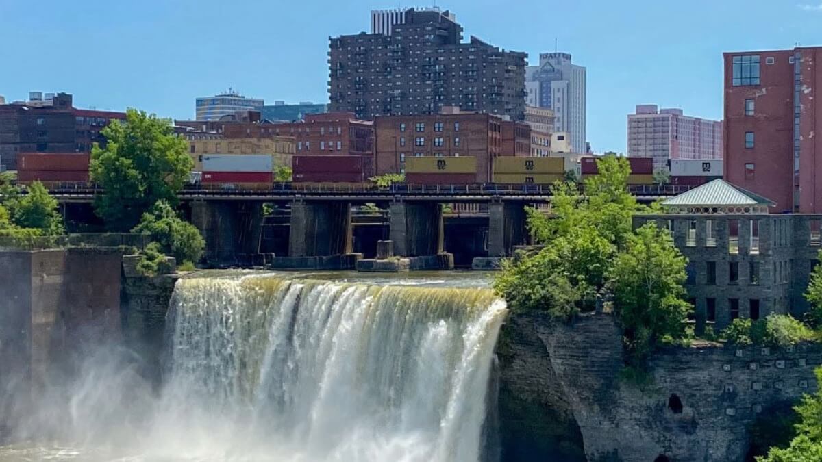 One of the waterfalls in Rochester with the Rochester skyline in the background.