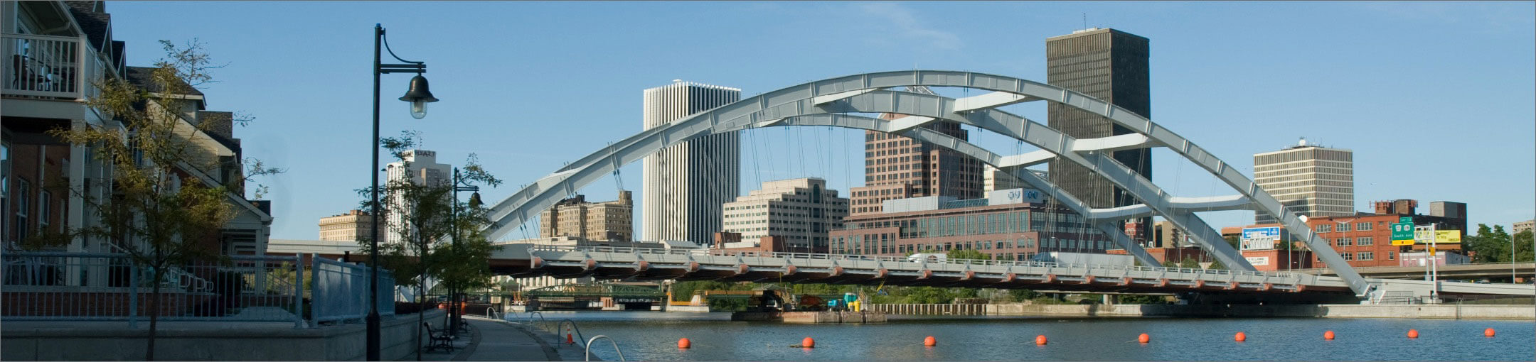 A bridge with the Rochester skyline in the background.