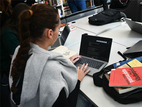 picture of student studying at the library