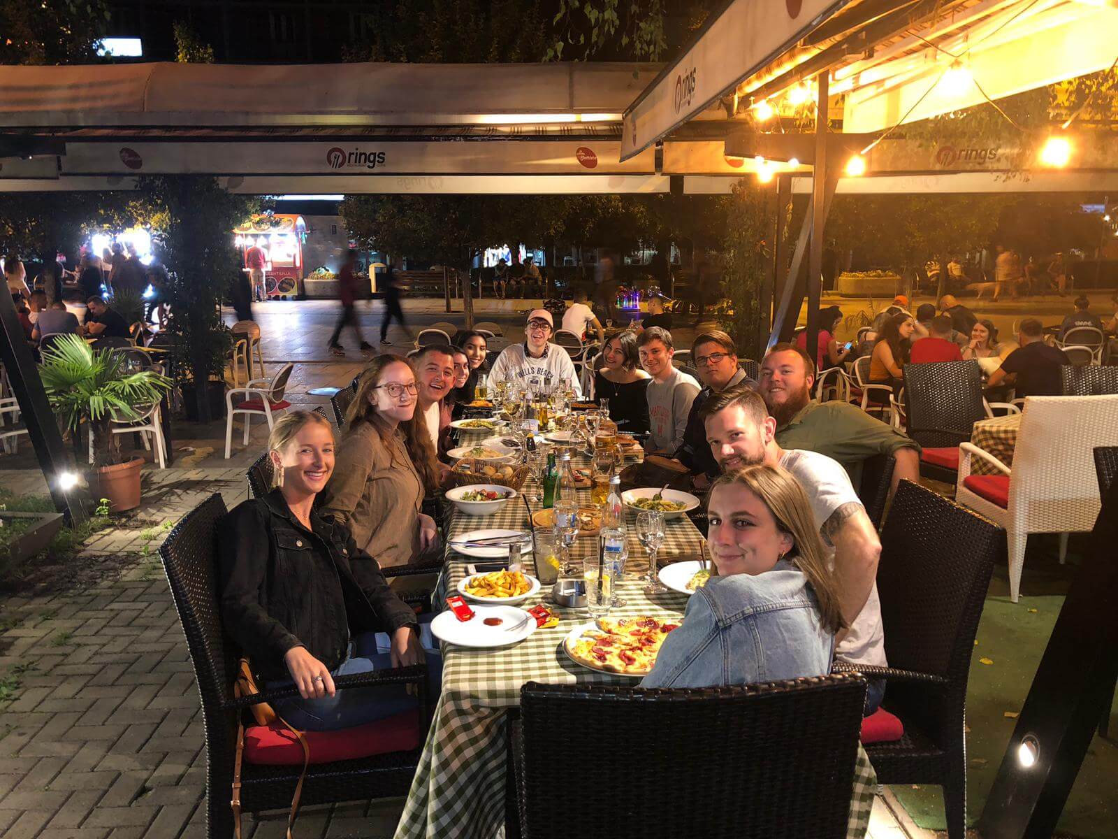 A group of people dining together outside.