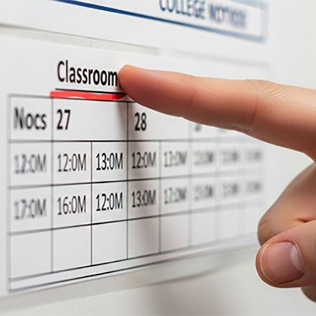 A finger pointing to a calendar.