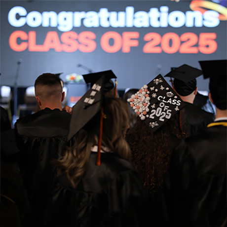 Students at a graduation, in their caps and gowns.