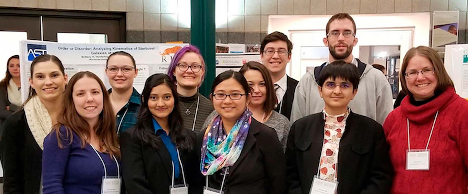 a group of researchers posing for a photo at a conference.