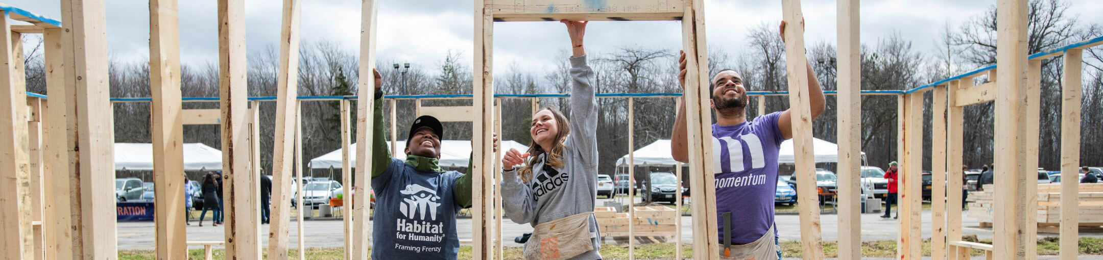 R I T students putting up framing for a house as part of a Habitat for Humanity event.