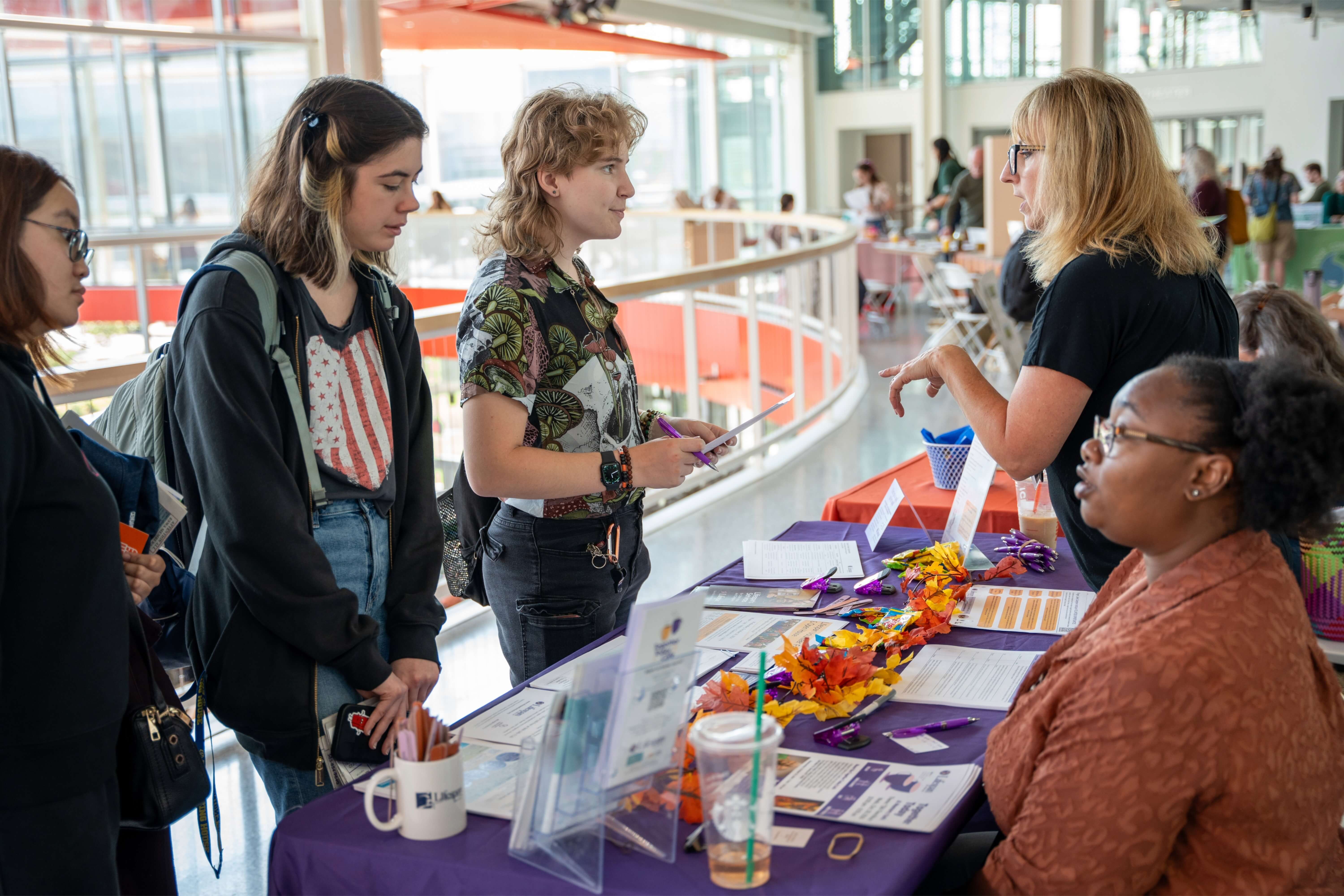 Students speaking with various representatives of different organizations in the Rochester community 