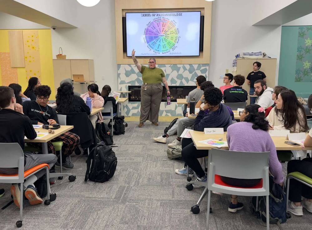 Students looking at a screen during a momentum presentation