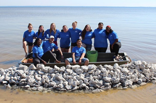 group of people in and around a small boat.