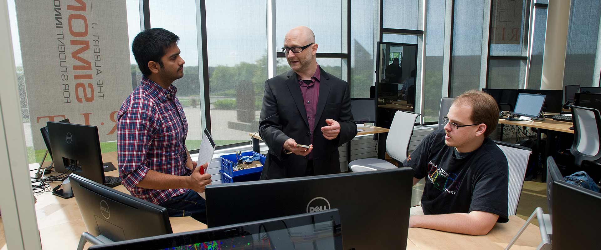 Professor Gottlieb talking with two students.