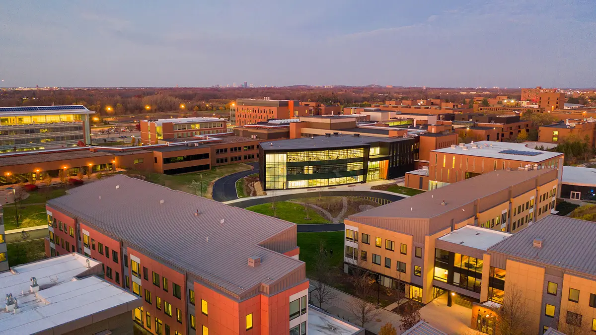 Aerial view of the R I T Campus at dusk with the Cybersecurity Institute in the middle.