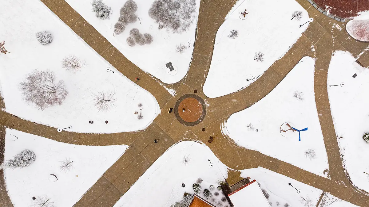 Aerial view of cleared walkways on campus during the winter.