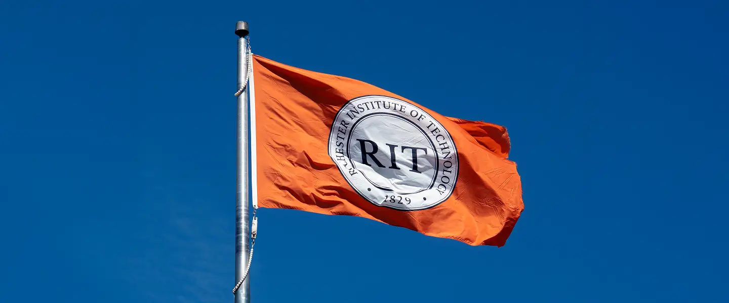 The R I T flag flying.