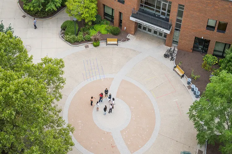 Aerial view of a group of students standing in a quad.