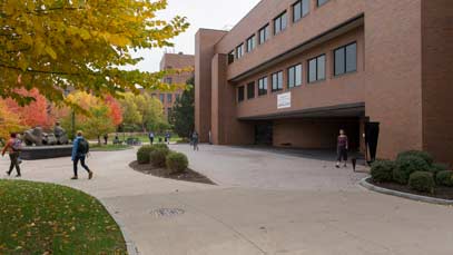 Students walking across campus on a fall day
