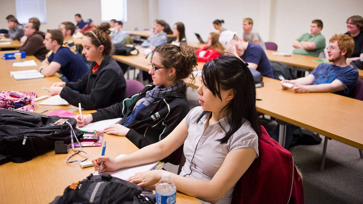 students listening attentively in a lecture hall.