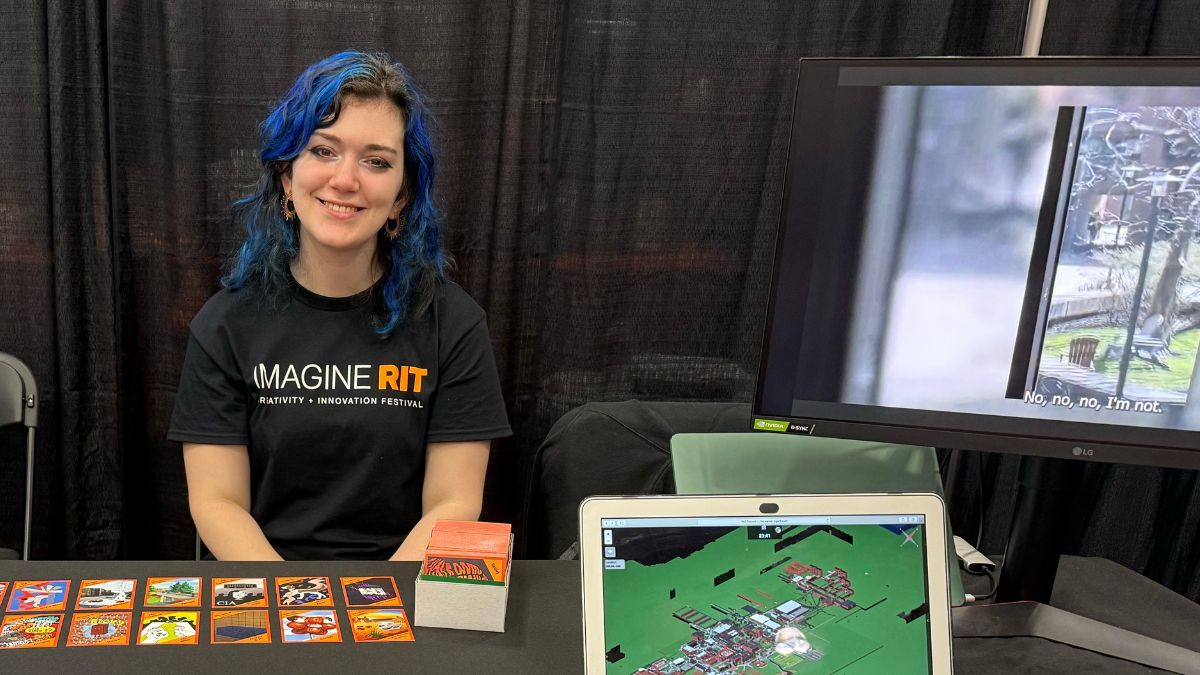 An student in the Humanities, Computing, and Design program presenting at Imagine RIT.