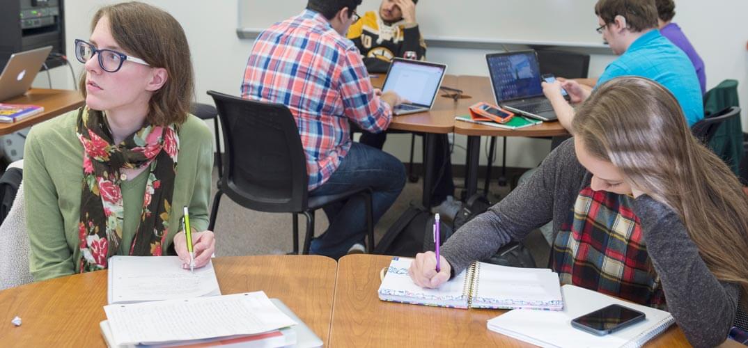 Students sitting around tables and working