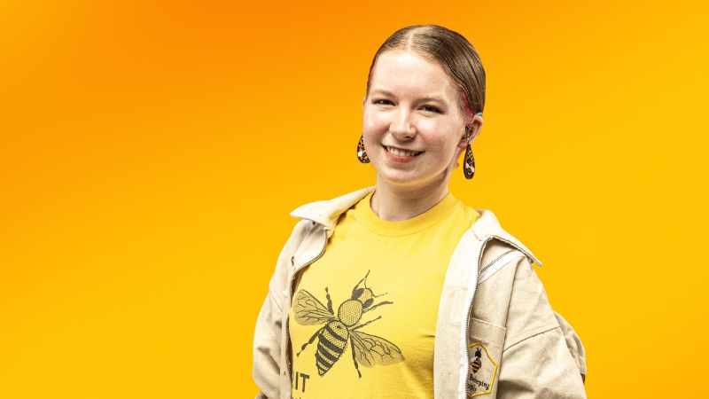 ellie in the portrait studio wearing her beekeeping attire
