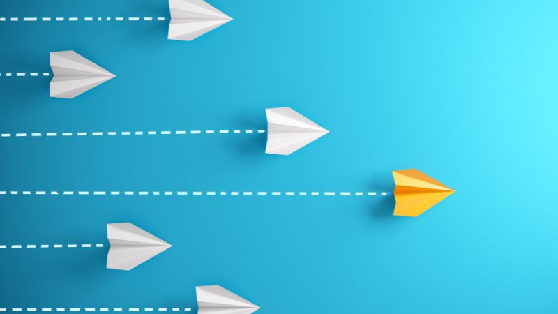 to illustrate leadership an image of a group of paper planes with one out in front
