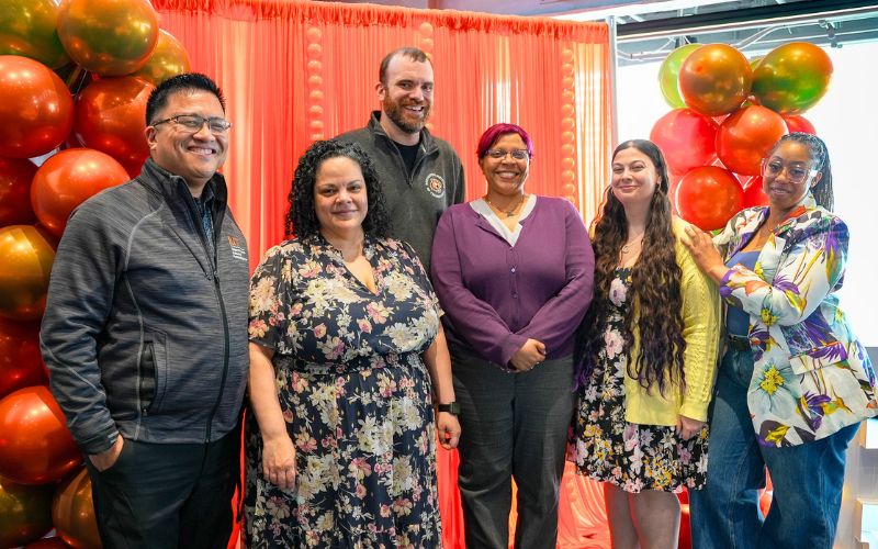 employees pose for a photo
