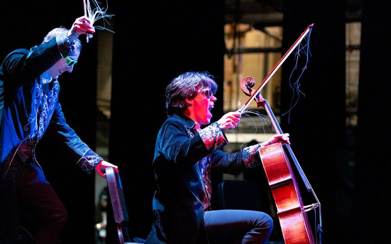 two music students performing under dramatic lighting