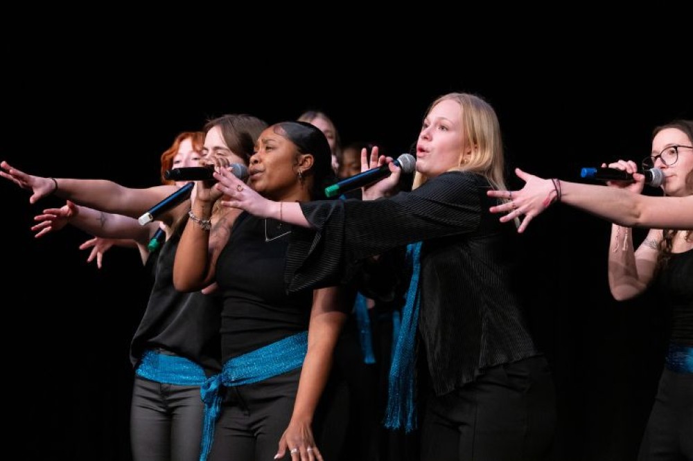 students on stage singing at rit