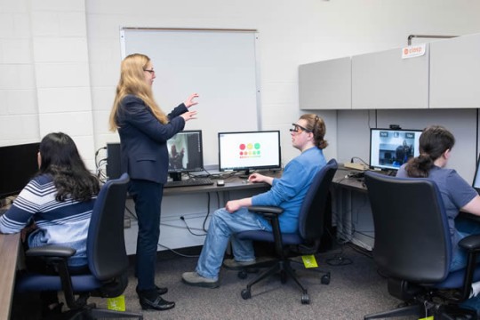a professor and students in the CLaSP lab at RIT