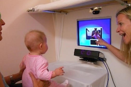 Baby looking at images on computer monitor.