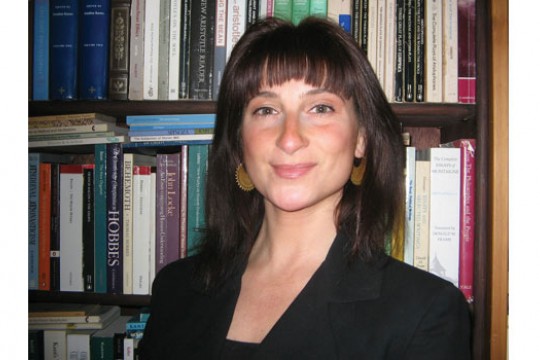 Professor posing in front of books