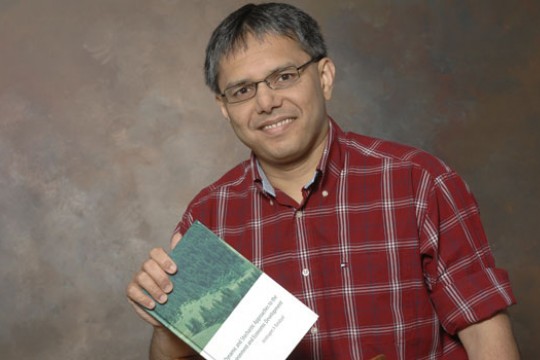 RIT Professor holding book