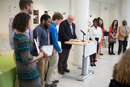 People accepting awards at event conference