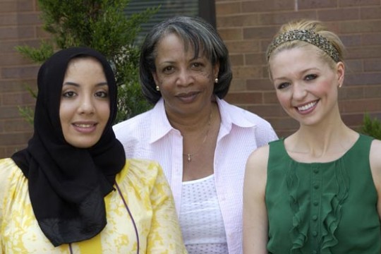 Two Students and Professor posing for camera