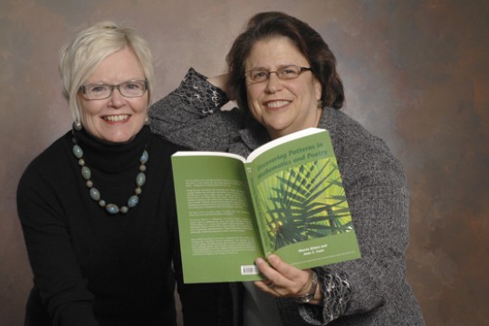 Two Professors holding a book