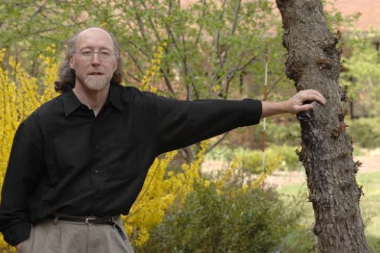 RIT Professor posing near a tree
