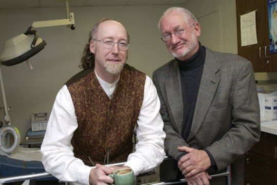 Two writers standing beside each other in office