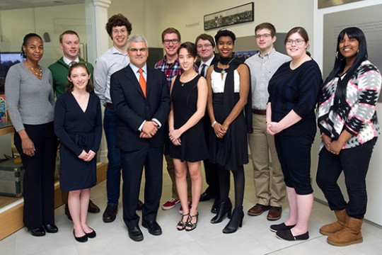 Students and professor gathered in classroom for picture
