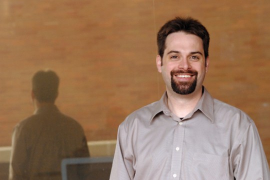 Person posing in front of window