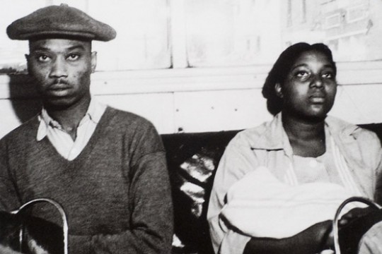 Old photo of two people sitting down