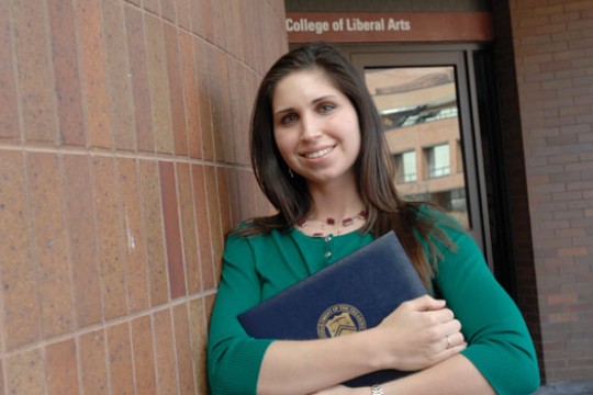 Person posing for camera outside building