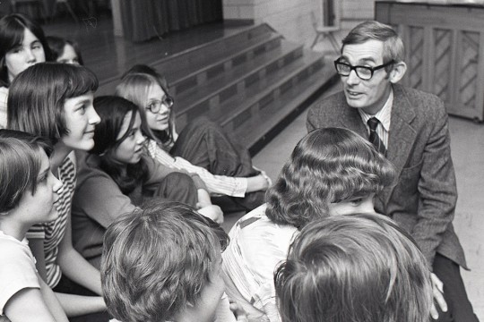 professor talking with students in 1977.