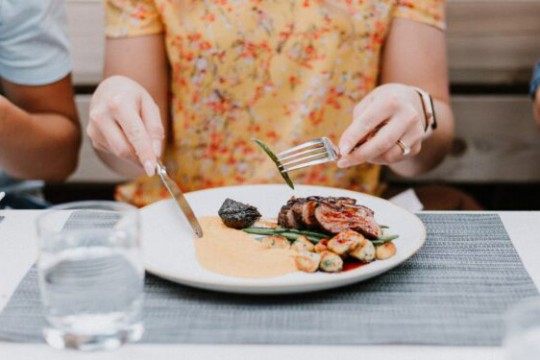 person eating steak and green beans.