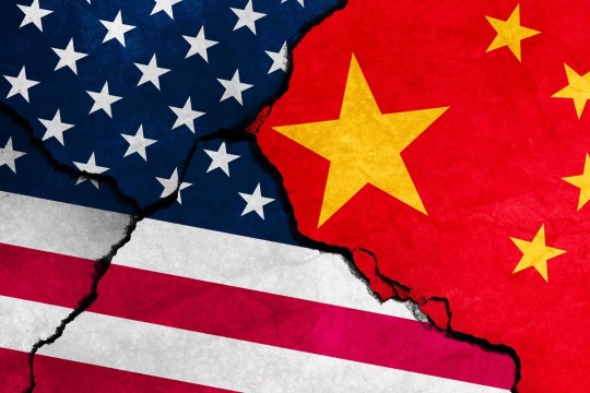 a united states flag and a chinese flag meet in the middle with a crack