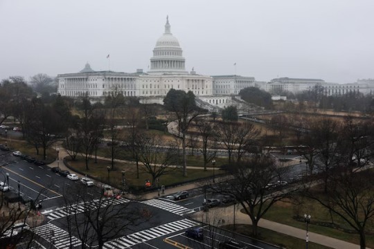 An aerial view of the U.S. Capitol Building on an overcast day.  