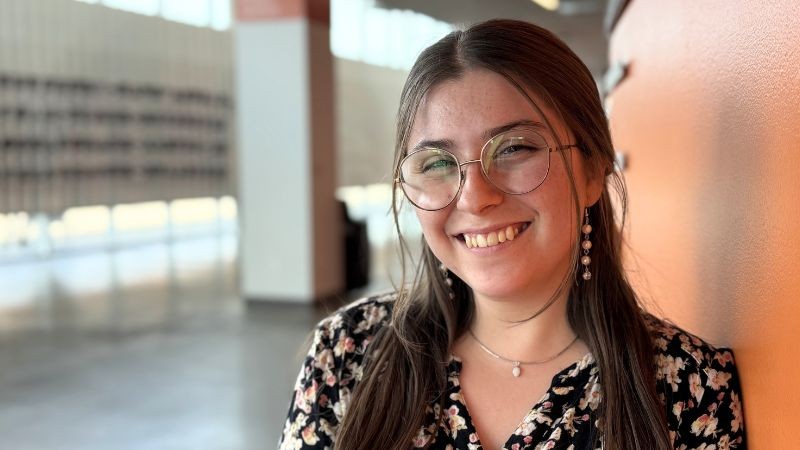 elly posing for a photo in the RIT polessini center lobby