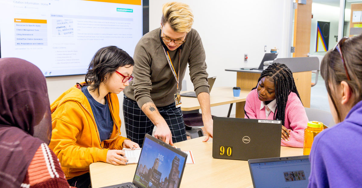 A librarian teaching students in a library