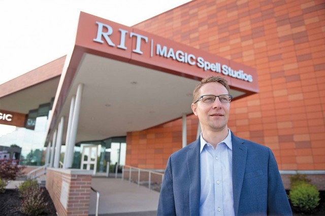 David Long stands outside of MAGIC Spell Studios building on RIT campus.