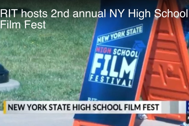 a sandwich board advertises a film festival on the R I T campus