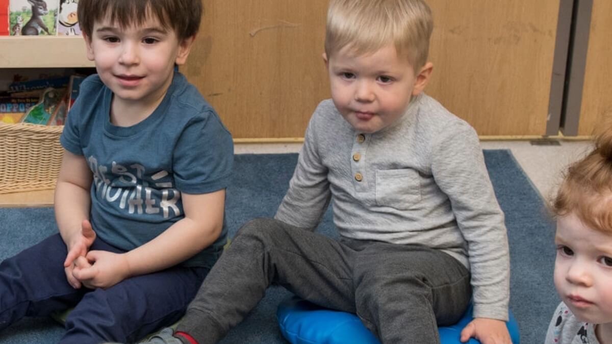 Students listen as a Margaret's House teach reads to them